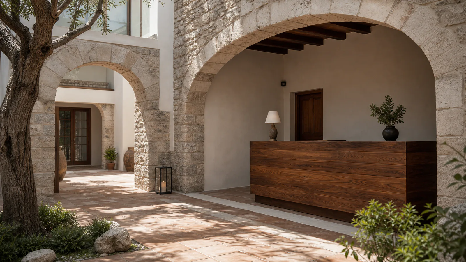 Taş kemer altında masif ceviz karşılama bankosu bulunan butik otel resepsiyonu