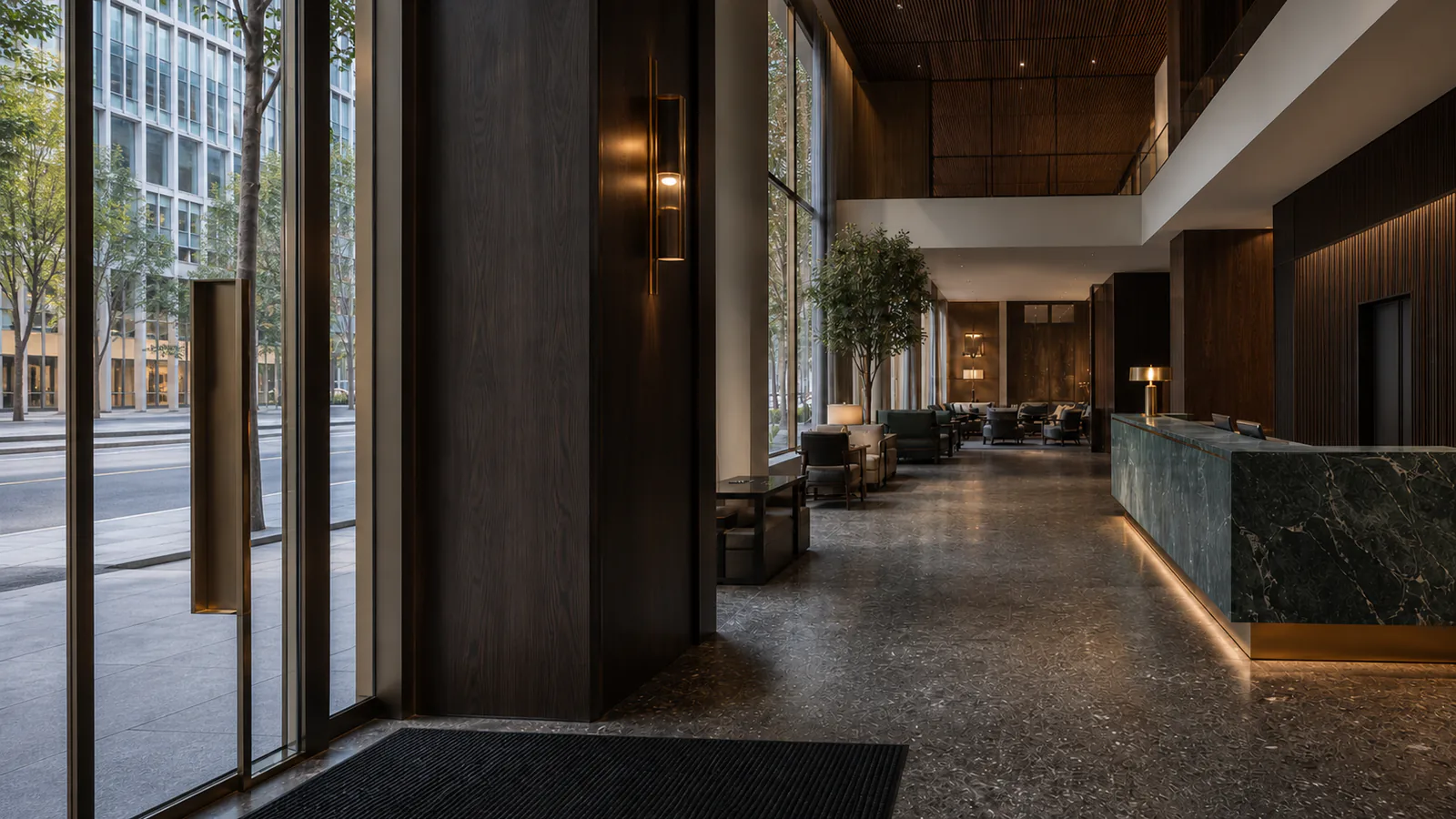 Koyu meşe giriş portalından yeşil taş resepsiyon ve lounge alanına açılan şehir oteli eşiği